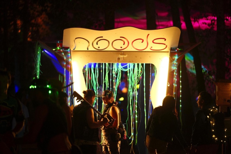 The Noodle Box installation, a lit box structure hung with pool noodles